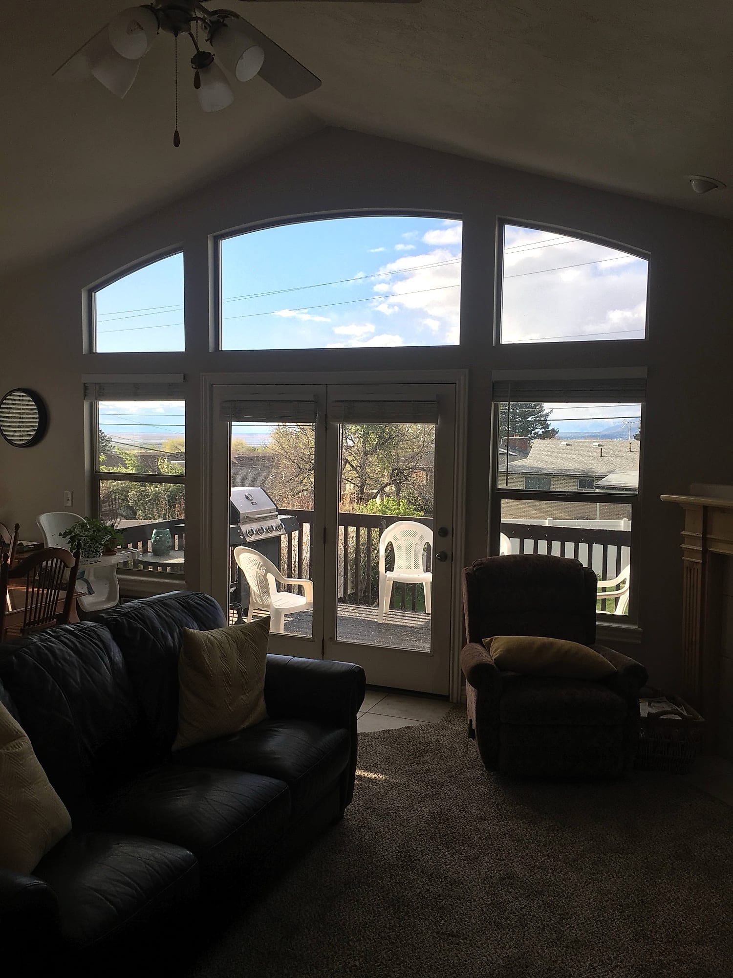 Arched transom windows above a set of french patio doors, looking out over a valley